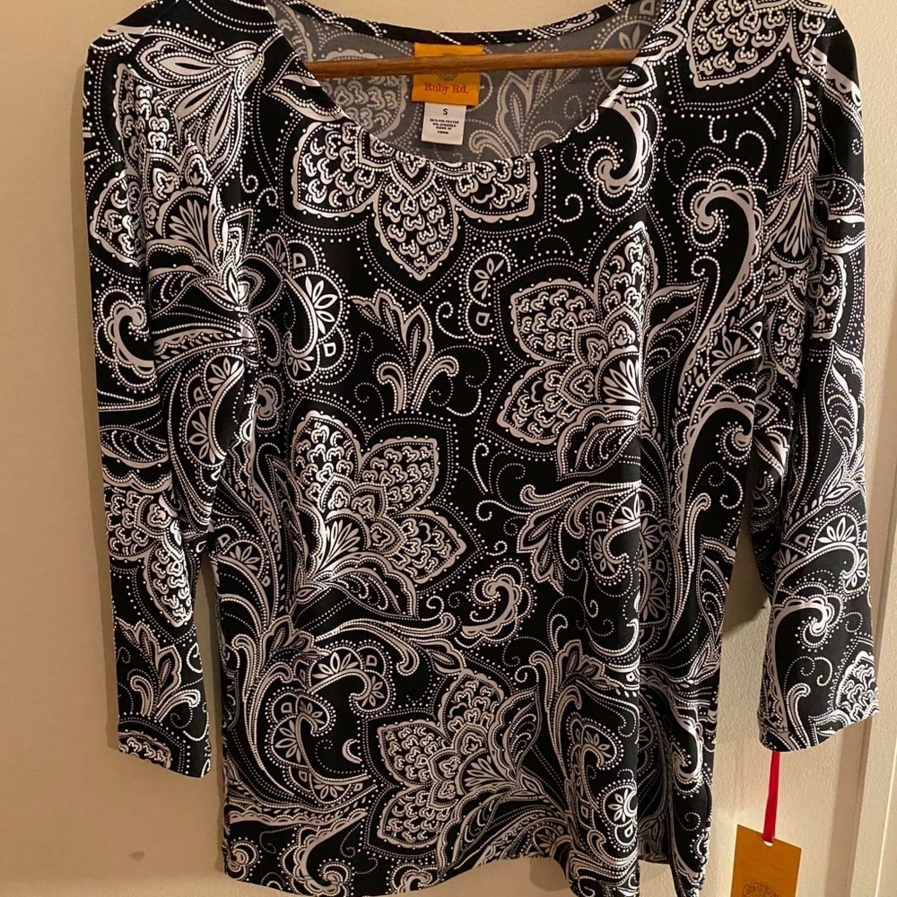 Black, with white print, blouse.